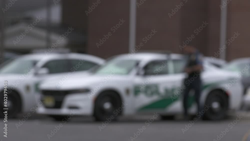 Police Walking through Precinct Parking Lot Blurry 4K Police Walking through Precinct Parking Lot Blurry 4K
