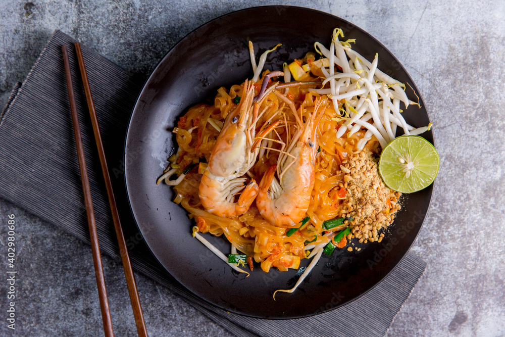 Udon Pad Thai with shrimp in a dark background, top view Asian style food Copy space Udon Pad Thai with shrimp in a dark background, top view Asian style food Copy space