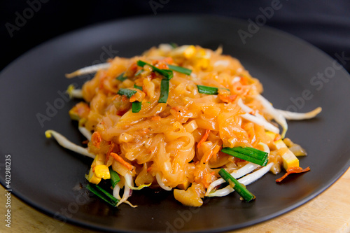 Vegetarian Pad Thai Udon noodles on a black plate Vegetarian Asian style Copy space