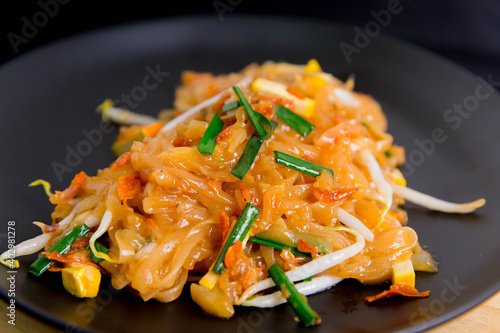 Vegetarian Pad Thai Udon noodles on a black plate Vegetarian Asian style Copy space