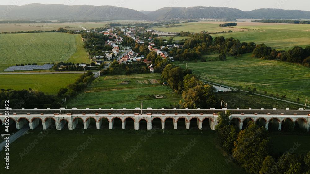 Aerial view of the railway viaduct near Lipnik nad Becvou with the surrounding countryside and the village lying nearby during the late afternoon. Aerial view of the railway viaduct near Lipnik nad Becvou with the surrounding countryside and the village lying nearby during the late afternoon.
