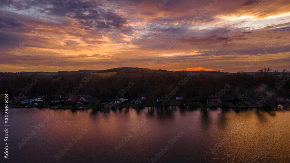 Aerial view of several divided ponds in a row during sunset in the area of Hustopece nad Becvou.