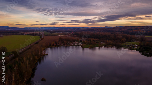 Aerial view of several divided ponds in a row during sunset in the area of Hustopece nad Becvou.
