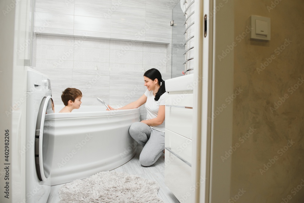 Mother washing little son in bathroom Mother washing little son in bathroom