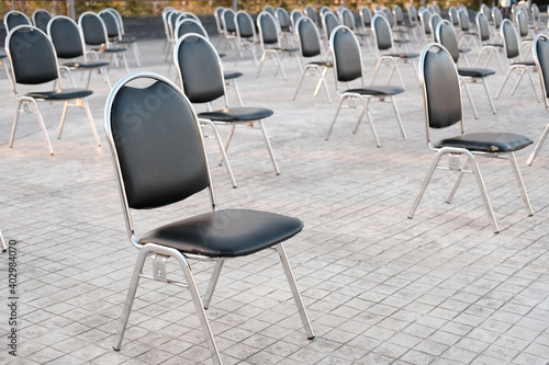 empty black chairs on concrete floor,social distancing