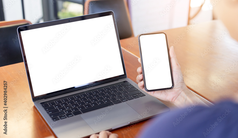 computer screen,cell phone blank mockup.hand woman work using laptop texting mobile.with white background for advertising,contact business search information on desk in cafe.marketing,design computer screen,cell phone blank mockup.hand woman work using laptop texting mobile.with white background for advertising,contact business search information on desk in cafe.marketing,design