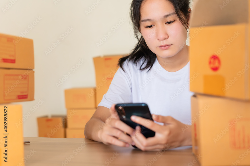 Young entrepreneur owns a teenage business. Are running their own business at home through the lifestyle that people now order Shop online even more, Concept social network, online shopping.