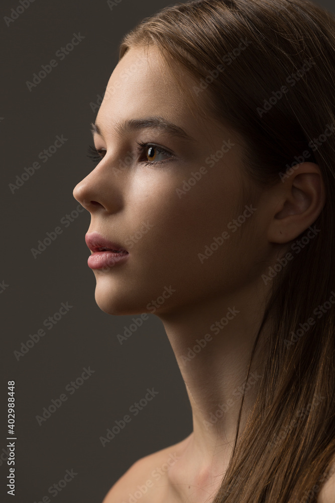 portrait of a beautiful teenage girl with exquisite makeup on a dark gray background portrait of a beautiful teenage girl with exquisite makeup on a dark gray background
