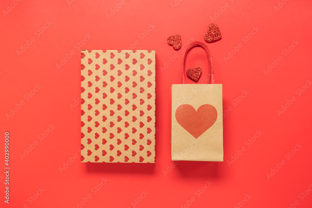 Valentines Day background with gifts, hearts and confetti top view flat lay on red. Copy space. banner valentine's day birthday background Valentines Day background with gifts, hearts and confetti top view flat lay on red. Copy space. banner valentine's day birthday background