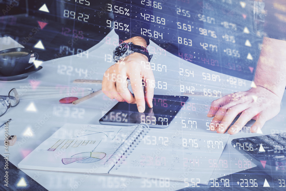Double exposure of man's hands holding and using a digital device and forex graph drawing. Financial market concept. Double exposure of man's hands holding and using a digital device and forex graph drawing. Financial market concept.