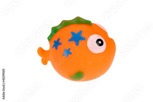Orange rubber toy fish. On a white background, isolated.
