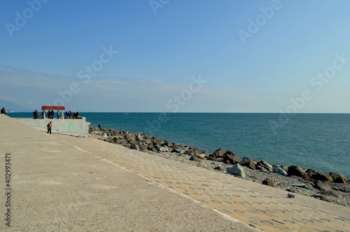 Embankment of a seaside resort town overlooking the sea and mountains
