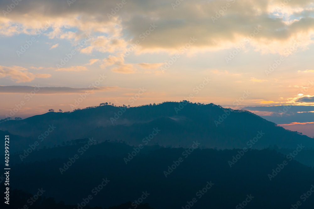 Silhouettes of mountains at sunrise