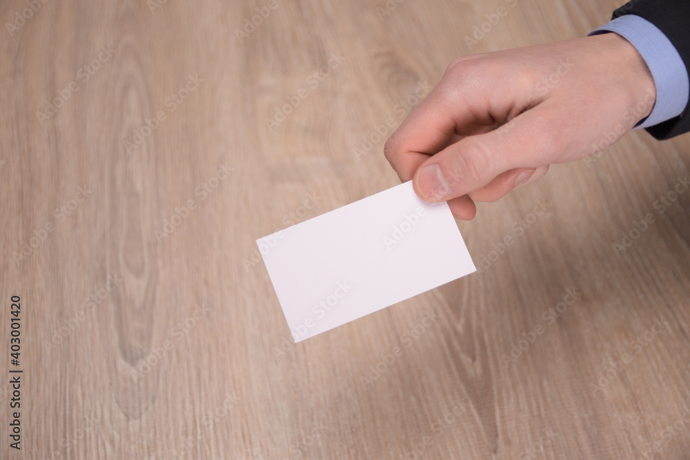 Obraz premium Hand hold blank white card mockup with rounded corners. Plain call-card mock up template holding arm. Plastic credit namecard display front. Check offset card design. Business branding.