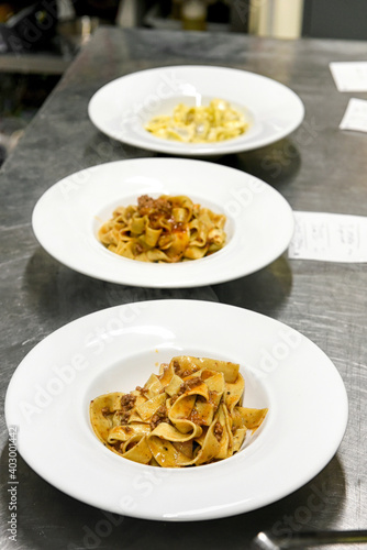 Bowls on a restaurant counter with tagliatelle dishes