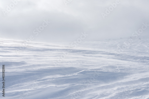 Textured surface of a snow-covered slope. Selective focus.