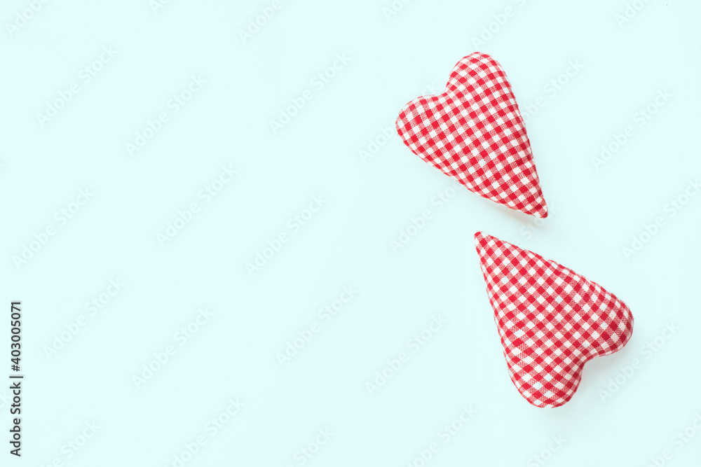 Obraz premium Valentines day composition. Two soft red hearts on pastel blue background. Flat lay, top view, copy space