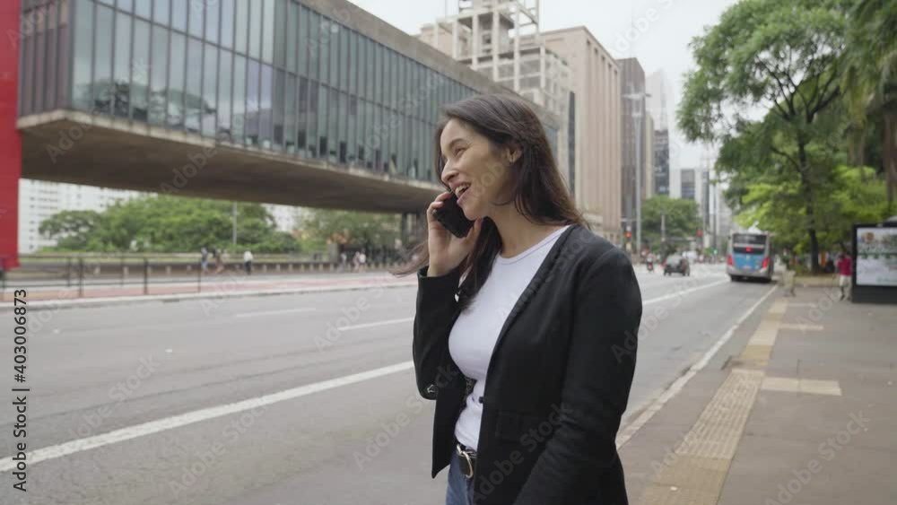 Business Woman is Talking on Phone Outside near Modern Building
Business Woman is Talking on Phone Outside near Modern Building