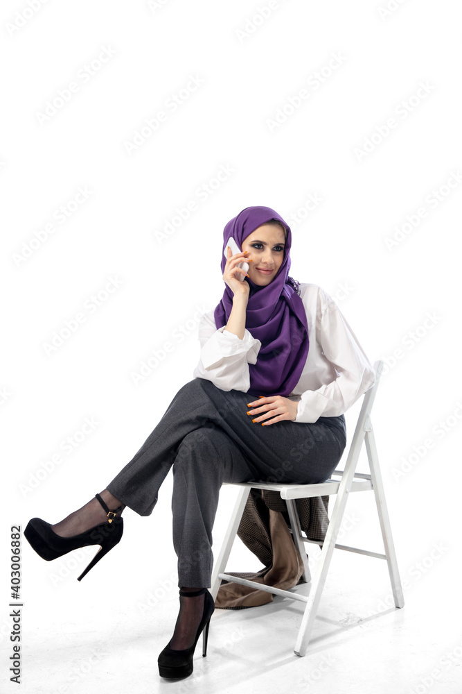 Lady boss. Modern arab woman in stylish office attire isolated on studio background with copyspace for ad. Fashion, beauty, style concept. Female model with trendy make up, manicure and accessories. Lady boss. Modern arab woman in stylish office attire isolated on studio background with copyspace for ad. Fashion, beauty, style concept. Female model with trendy make up, manicure and accessories.
