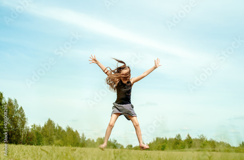 Girl, jumping in the field.running and jumping. happy childhood, hot summers, freedom and lifestyle. wind in hair