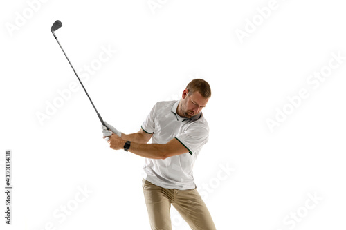 Half length. Golf player in a white shirt taking a swing isolated on white studio background with copyspace. Professional player practicing with bright emotions and facial expression. Sport concept.