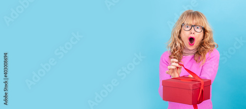 surprised adult woman with gift box isolated