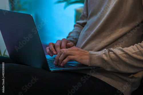 close-up of hands typing on laptop