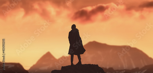 a silhouette girl in peak of winter mountains with golden sunset.