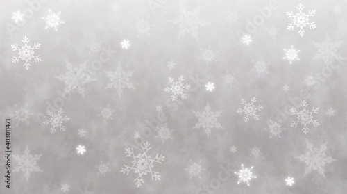 薄いグレーの背景にうすい雪の結晶、寒い冬のイメージ