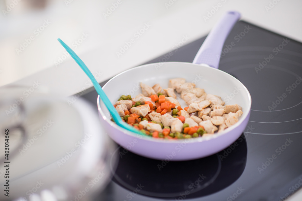Preparing food in modern white kitchen Preparing food in modern white kitchen