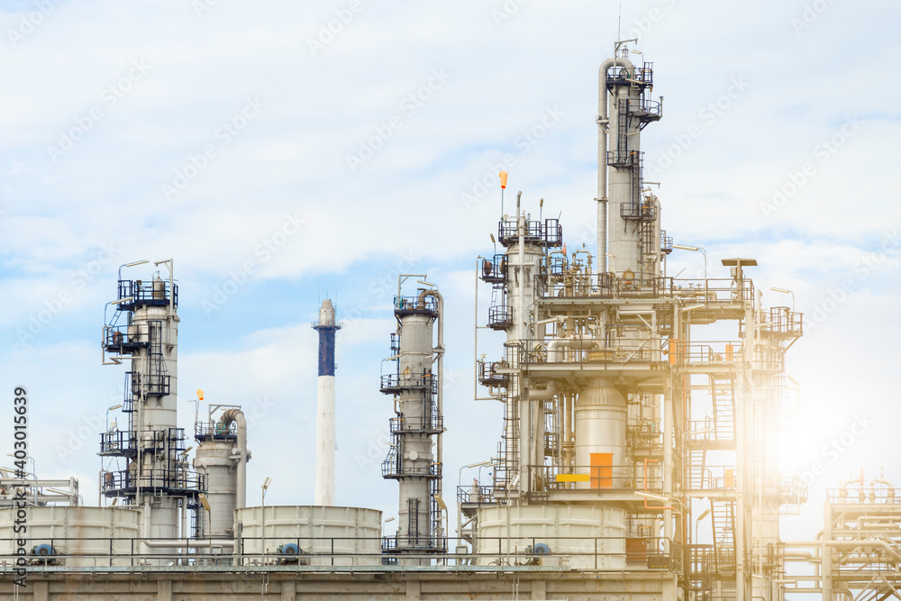 Fototapeta premium Industrial of oil refinery plant from industry zone ,Refinery factory oil storage tank and pipeline steel with blue sky.