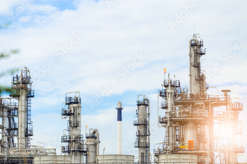 Industrial of oil refinery plant from industry zone ,Refinery factory oil storage tank and pipeline steel with blue sky.
