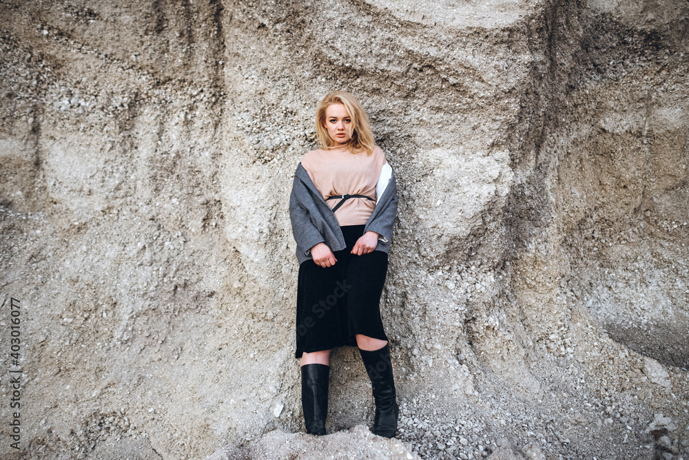Portrait of a red-haired girl after sunset between the mountains. Psychological portrait of loneliness. Concept with soft focus and night noise Portrait of a red-haired girl after sunset between the mountains. Psychological portrait of loneliness. Concept with soft focus and night noise