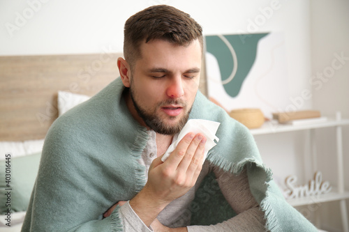 Quadro em tela Ill young man with runny nose at home