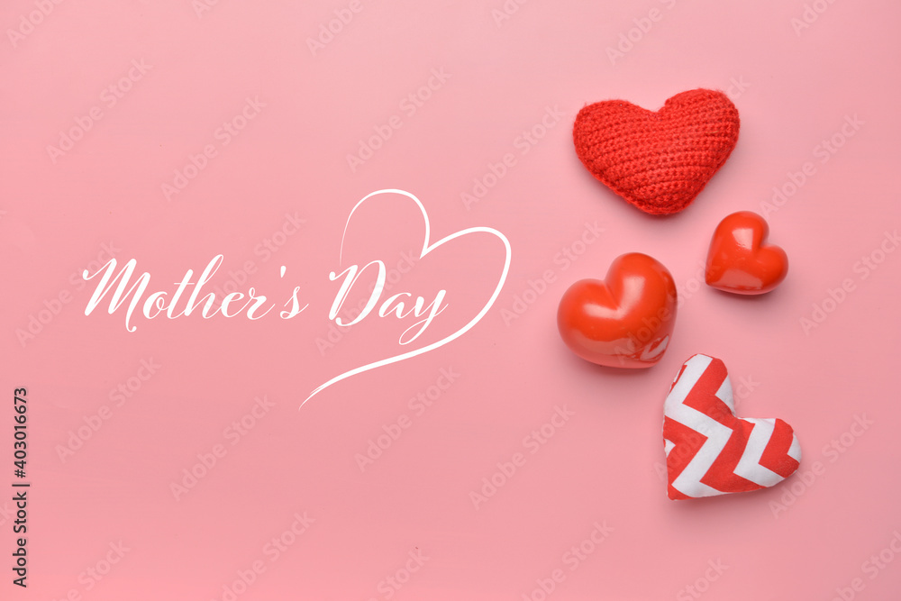 Text MOTHER'S DAY and beautiful hearts on color background