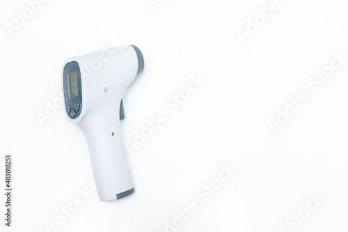 Temperature gun isolated on white background. Close up of laser thermometer with copy space for text.