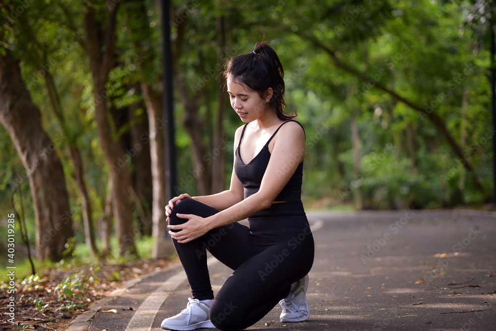 Asian woman is warm up, To make the muscles flexible Before going to jogging for good health and energy metabolism,Outdoors cross training workout. Healthcare concept Asian woman is warm up, To make the muscles flexible Before going to jogging for good health and energy metabolism,Outdoors cross training workout. Healthcare concept