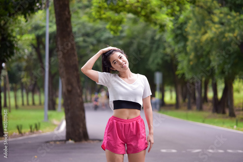 Asian woman is warm up, To make the muscles flexible Before going to jogging for good health and energy metabolism,Outdoors cross training workout. Healthcare concept