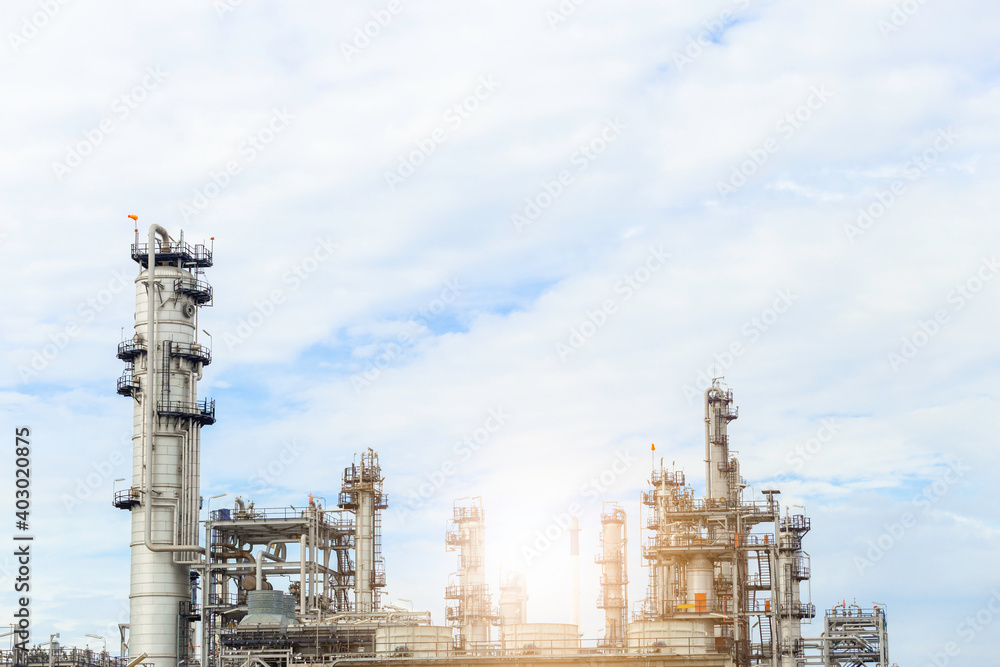 Industrial of oil refinery plant from industry zone ,Refinery factory oil storage tank and pipeline steel with blue sky.