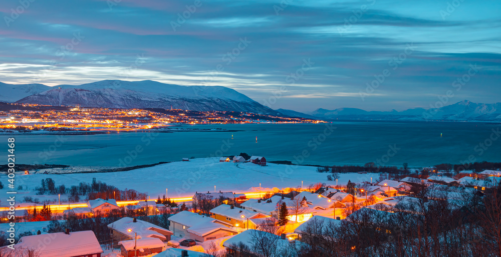 Beautiful winter or urban landscape of Tromso in Northern Norway at twilight blue hour - Arctic city of Tromso with bridge -Tromso, Norway