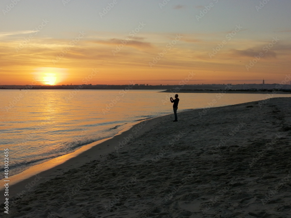 Sunset at beach with photographer