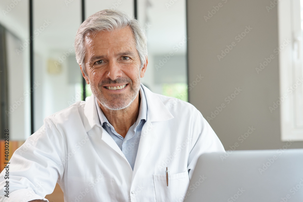 Portrait of attractive mature doctor working in office Portrait of attractive mature doctor working in office