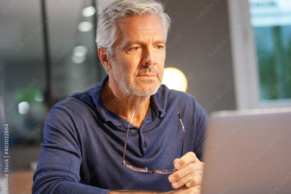 Portrait of senior man with grey hair connected with laptop Portrait of senior man with grey hair connected with laptop