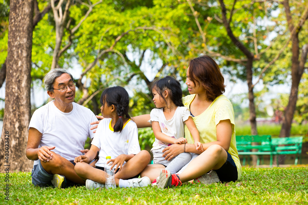 Generations in one image: grandmother, son and young grandchildren in the garden