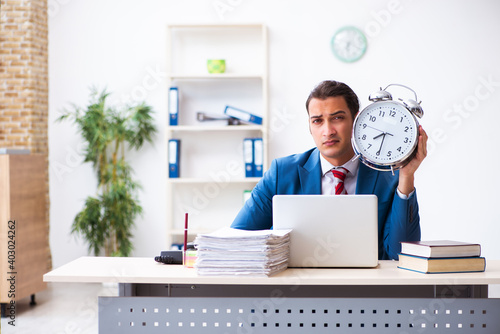 Young male employee working in the office