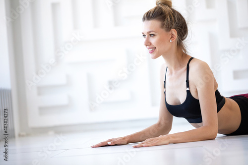 Young beautiful woman doing exercises on the floor. Workout.