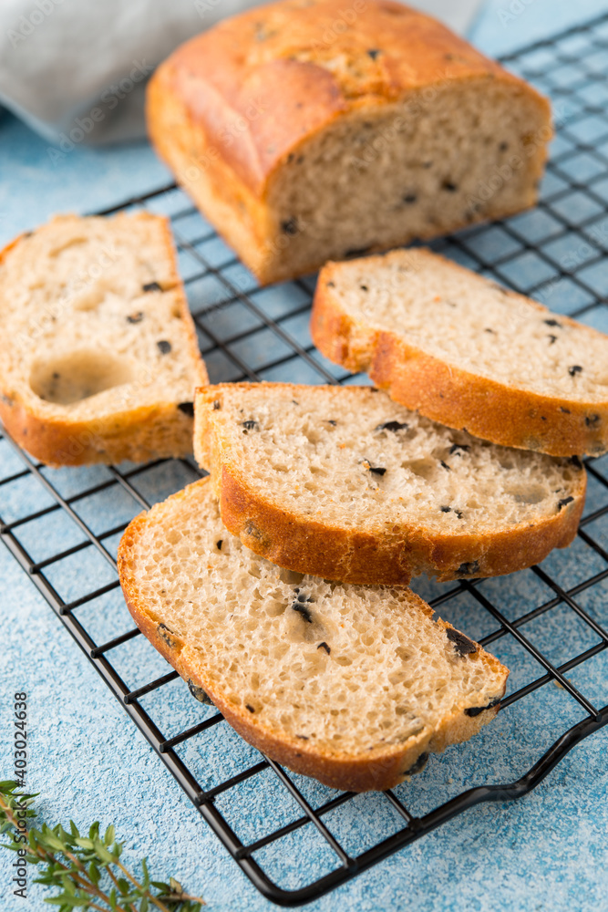 Homemade Italian ciabatta bread with herbs, garlic and olives, selective focus