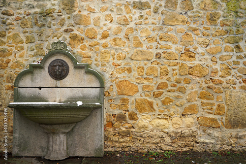 Drinking fountain at historic city wall in Amberg