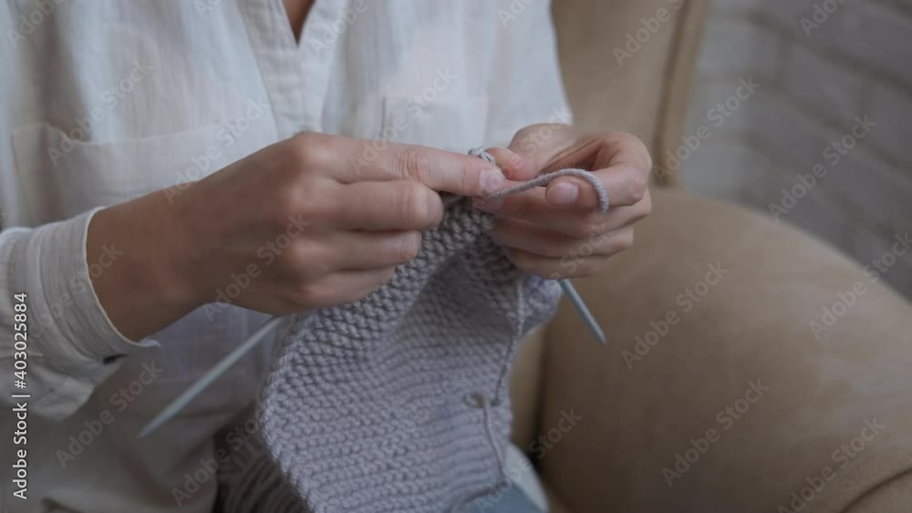 Hand with yarn. A woman knit with needles and wool threads in the room. Hand with yarn. A woman knit with needles and wool threads in the room.