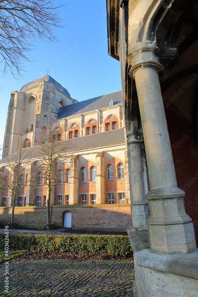 The external facade of Grote Kerk church with the column of the Cistern (historical landmark) in the foreground, Veere, Zeeland, Netherlands